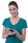 Pretty Woman Using Touch Screen Cellphone Stock Photo