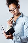 Pretty Young Black Woman Taking Notes At Home Stock Photo