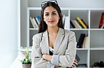 Pretty Young Businesswoman Looking At Camera In The Office Stock Photo