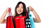 Pretty Young Chinese Girl Holding Shopping Bags Stock Photo