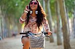 Pretty Young Girl Riding Bike And Talking On The Phone Stock Photo