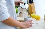 Pretty Young Woman Enjoying Breakfast In The Kitchen Stock Photo