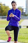 Pretty Young Woman Listening To Music After Running Stock Photo