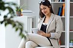 Pretty Young Woman Using Digital Tablet In The Office Stock Photo