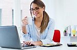 Pretty Young Woman Using Her Laptop In The Office Stock Photo