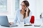 Pretty Young Woman Using Her Laptop In The Office Stock Photo