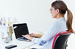 Pretty Young Woman Using Her Laptop In The Office Stock Photo