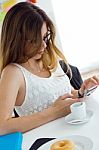 Pretty Young Woman Using Her Mobile Phone At Home Stock Photo