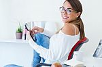 Pretty Young Woman Using Her Mobile Phone In The Office Stock Photo