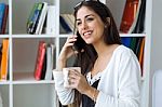 Pretty Young Woman Using Her Mobile Phone In The Office Stock Photo