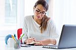 Pretty Young Woman Working In Her Office Stock Photo