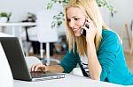 Pretty Young Woman Working With Laptop At Home Stock Photo