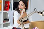 Pretty Young Woman Working With Laptop In Her Office Stock Photo