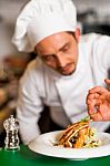 Professional Chef Preparing Baked Salmon To Be Served Stock Photo