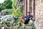 Punk Girl Sitting On The Porch Of An Old Castle Stock Photo