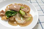 Rad Na, Famous Thai Chinese Style Wide Rice Noodle Dish With Tasty Tender Pork With Thick Gravy Sauce. Close Up Stock Photo