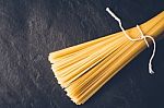 Raw Spaghetti On The Black Stone Background Stock Photo