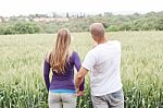 Rear View Of Young Couple Viewing The Lawn Stock Photo