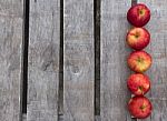 Red Apples On Rustic Wooden Background Stock Photo