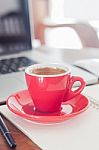 Red Coffee Cup With Notepad And Laptop Stock Photo