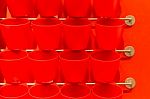 Red Plastic Cup Display On Wall Stock Photo