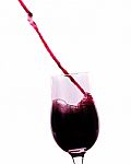 Red Wine Flowing Into The Glass Stock Photo