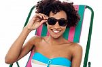 Relaxing Female Model Adjusting Her Shades Stock Photo