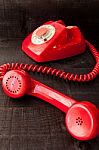 Retro Vintage Red Landline Unhang On Wooden Background Stock Photo