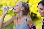 Running Girl Drinking Water After Running Stock Photo