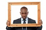 Sad Businessman With Wooden Frame Stock Photo