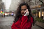 Sad Woman In Red Coat Hold On Mobile Phone, Smartphone, Urban Sc Stock Photo