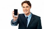 Salesman Displaying Newly Launched Mobile Stock Photo