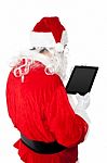 Santa Busy In Operating Tablet Pc Stock Photo