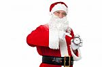 Santa Pointing At An Antique Time Piece Stock Photo