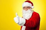 Santa Showing Thumbs Up Gesture To Camera Stock Photo