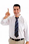 Satisfied Businessman Indicating Upwards Stock Photo