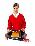 School Girl Seated On Floor Stock Photo