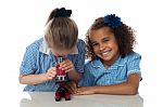 School Girls Using A Microscope In Lab Stock Photo