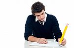 Schoolboy Writing On Notebook Stock Photo