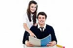 Schoolgirl Guiding Her Boy Friend Stock Photo