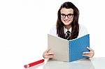 Schoolgirl Reading Books Stock Photo