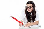 Schoolgirl Writing On Notebook Stock Photo