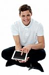 Seated Guy Using Touch Pad Device Stock Photo