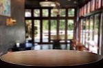 Selected Focus Empty Brown Wooden Table And Coffee Shop Or Resta Stock Photo