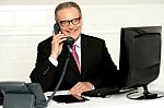 Senior Businessman Attending Phone Call Stock Photo