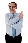 Senior Businessperson Pointing Away Stock Photo