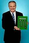 Senior Manager Showing Big Green Calculator Stock Photo