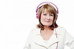 Senior Woman Listening To Music Stock Photo