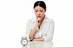 Serious Business Lady Staring At Alarm Clock Stock Photo