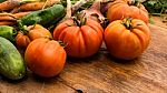 Several Vegetables On Wooden Chopping Board And Table Stock Photo